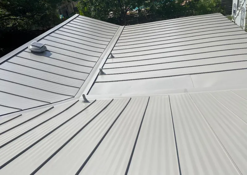 Solar attic fan installed on a metal roof for Roof Ventilation in Wyckoff
