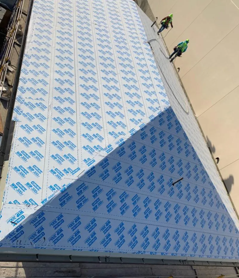 Professional roofers installing underlayment on a metal roof in Wyckoff